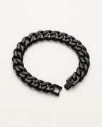 Black chain bracelet with Cuban curb links held in the hand