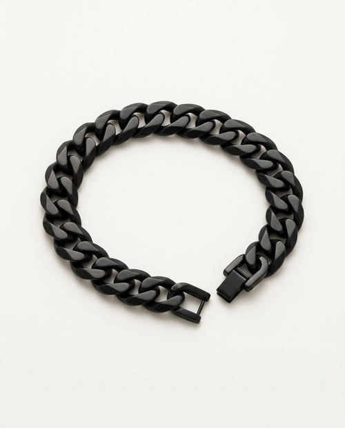 Black chain bracelet with Cuban curb links held in the hand