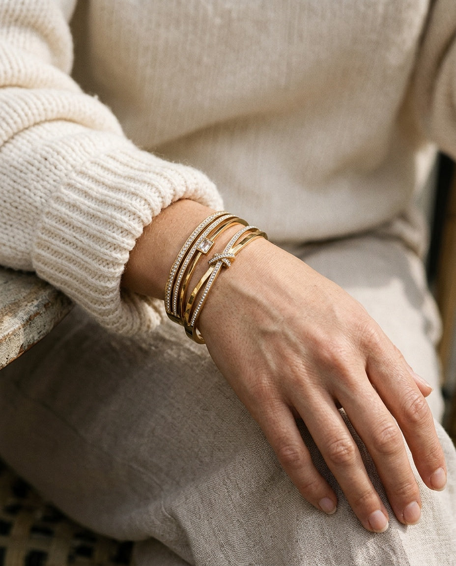 Gold bangles stacked on the wrist