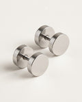 Mens stud earrings, flat round stainless steel discs on a plain background