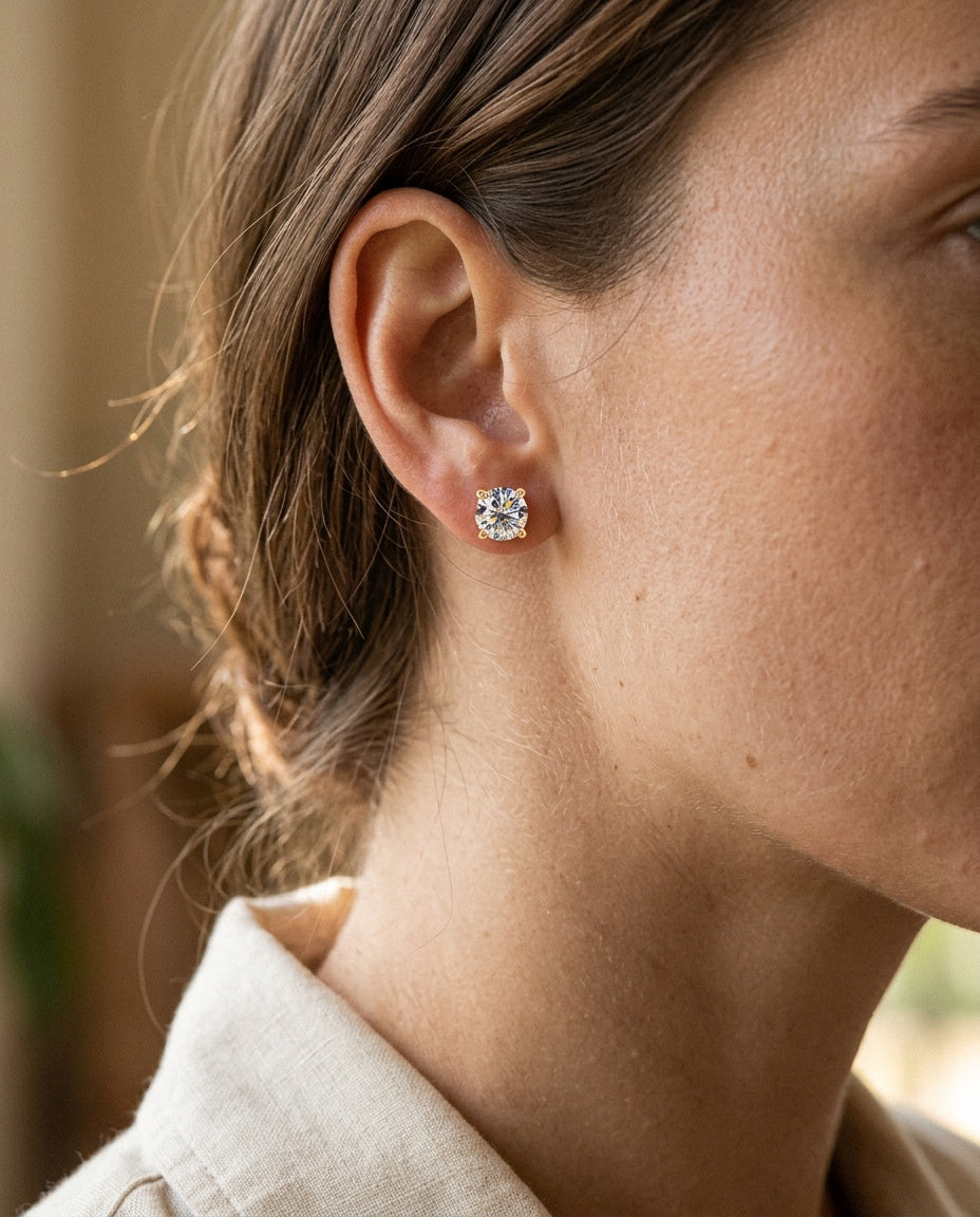 Stud earrings worn on the earlobe with hair pulled back