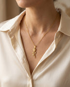 Flower necklace worn just below the collarbone