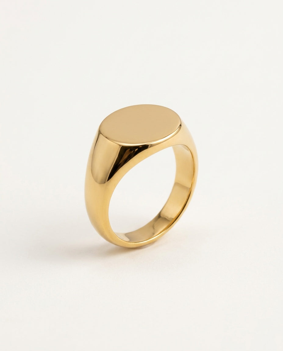 Gold oval signet ring with a smooth, polished top