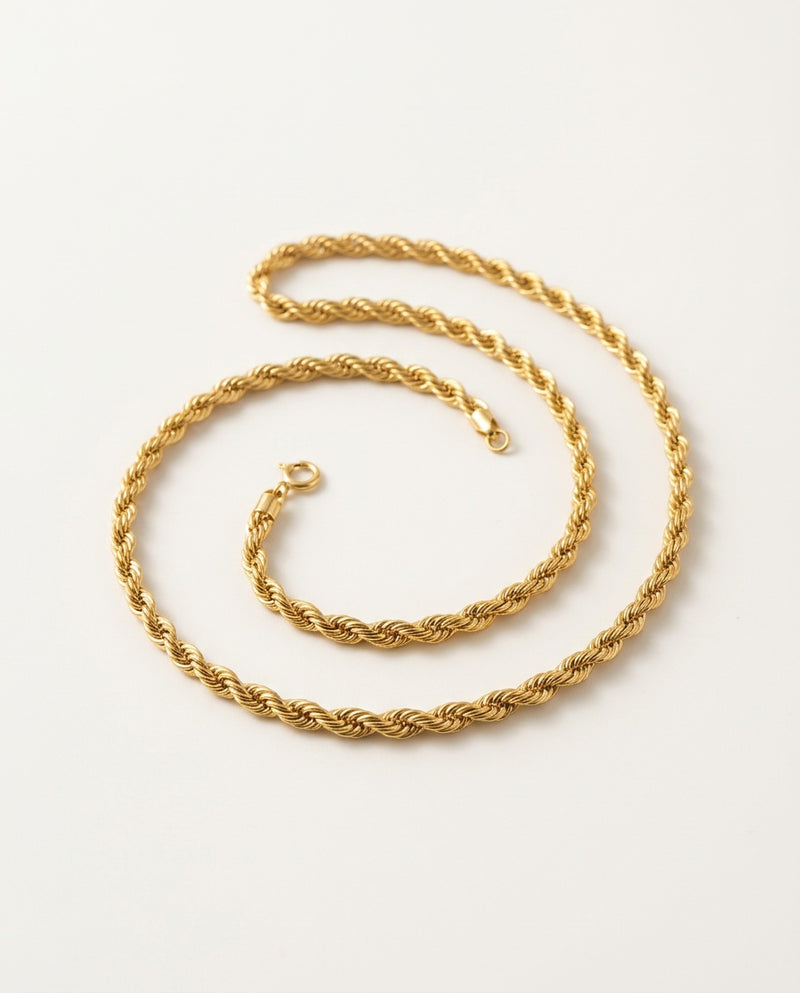Gold rope chain with twisted links on a white background