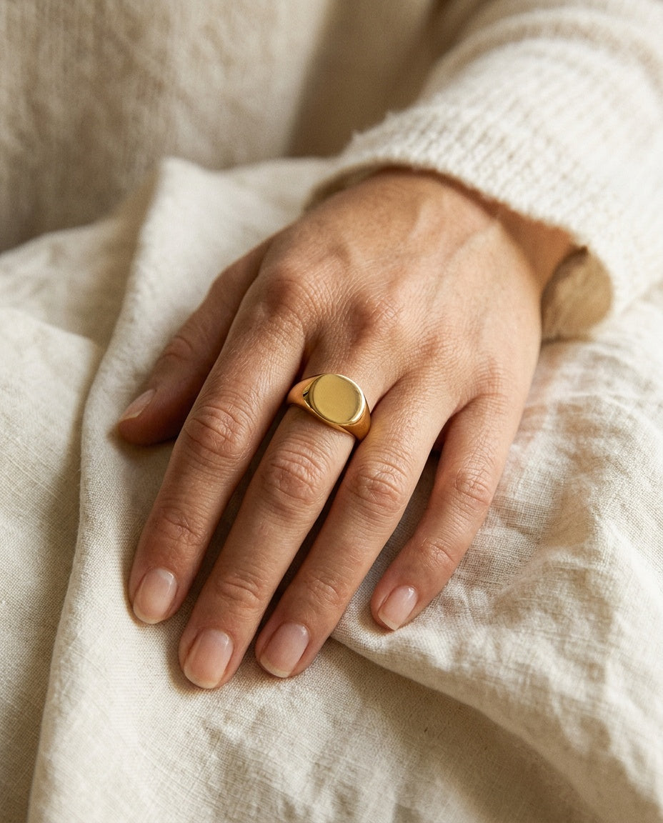 Women's signet ring worn on the pinky finger