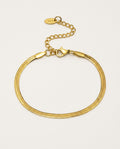 Gold chain bracelet in herringbone style on a light background