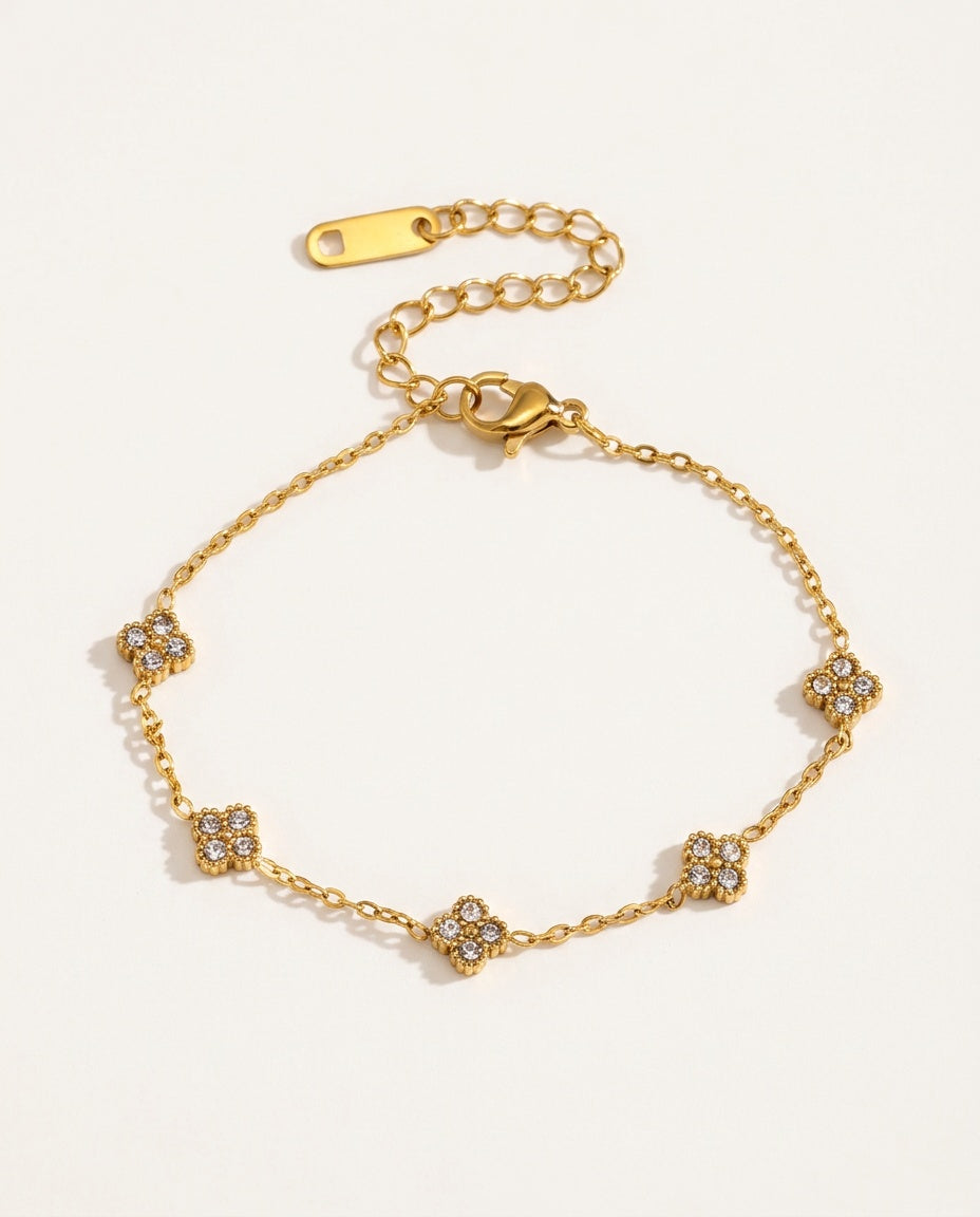 Gold flower bracelet with small zircon flowers on a fine chain