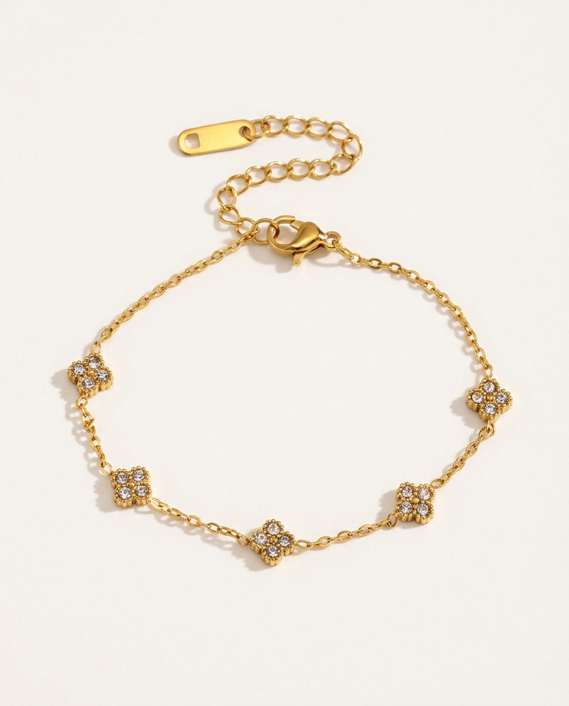 Gold flower bracelet with small zircon flowers on a fine chain