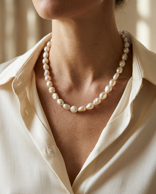 Pearl strand worn at the collarbones