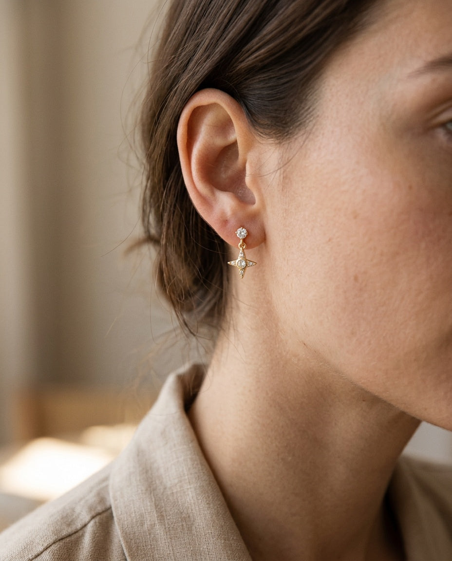 Star drop earring worn on the ear with hair up