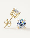 Moissanite stud earrings in a four-prong gold-tone setting