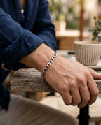 Curb link bracelet worn on a man's wrist with a T-shirt