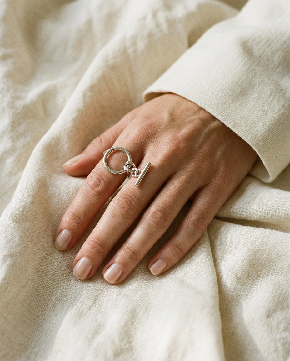 Silver chain ring worn on the index finger
