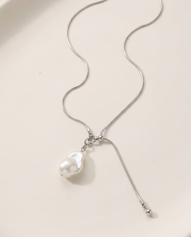 Long pearl necklace with a single baroque pearl on a fine chain
