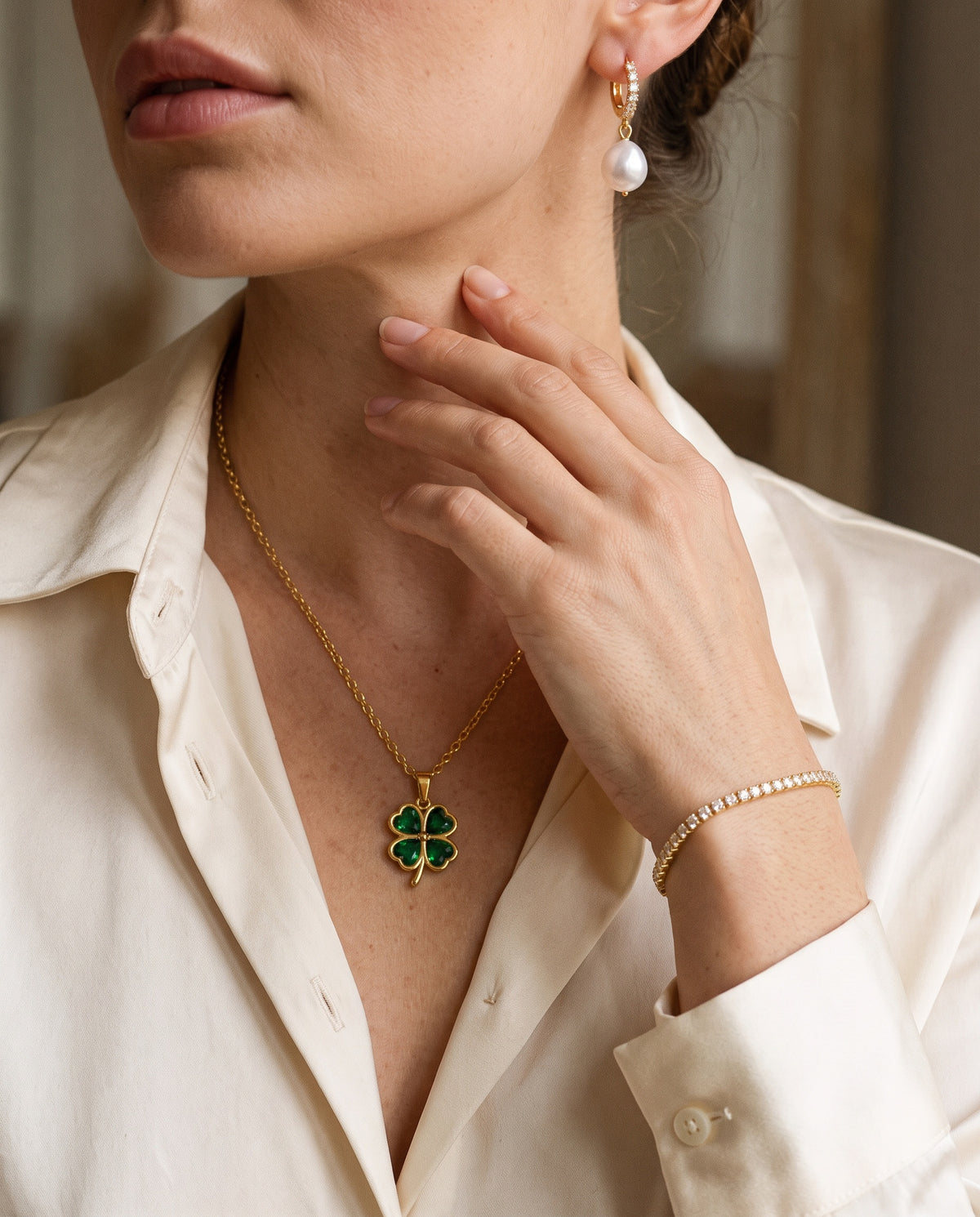 Clover necklace, pearl drop earrings and tennis bracelet worn together