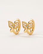 Gold butterfly earrings on small hoops with tiny clear stones