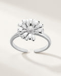 Gold daisy flower ring on an open adjustable band, on white