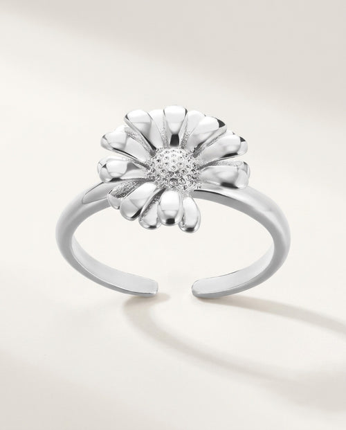 Gold daisy flower ring on an open adjustable band, on white