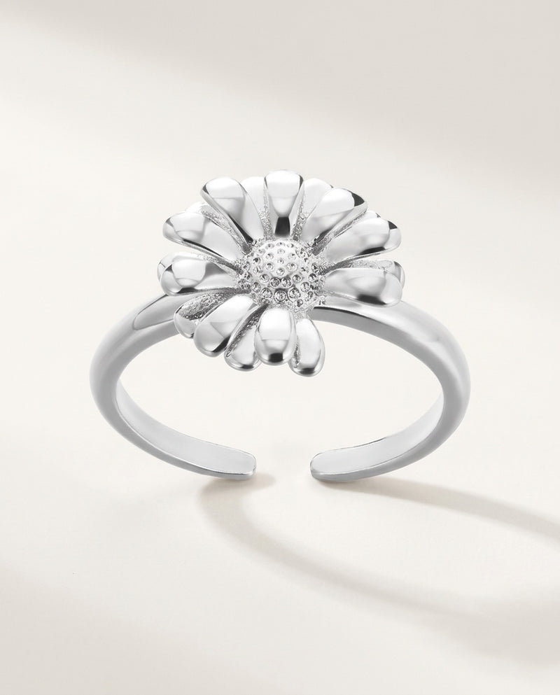 Gold daisy flower ring on an open adjustable band, on white