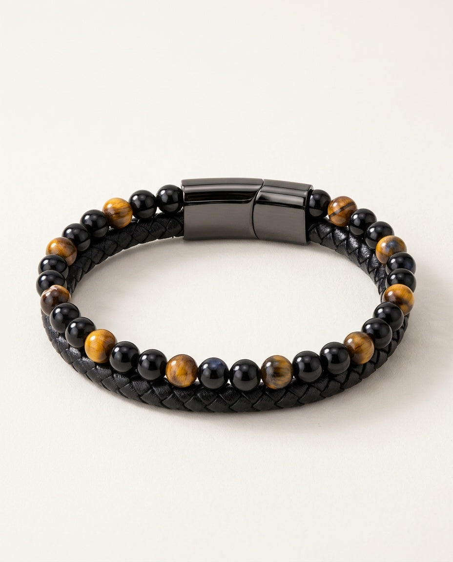 Tiger eye bracelet with yellow tiger eye and black beads next to braided leather