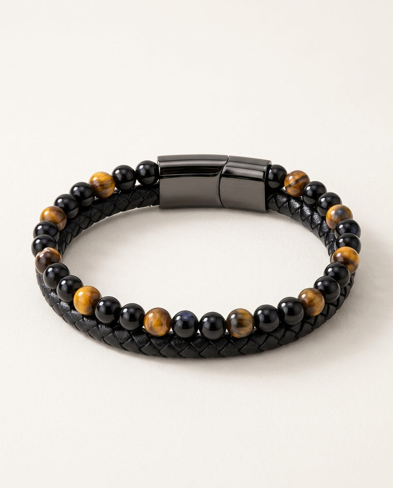 Tiger eye bracelet with yellow tiger eye and black beads next to braided leather
