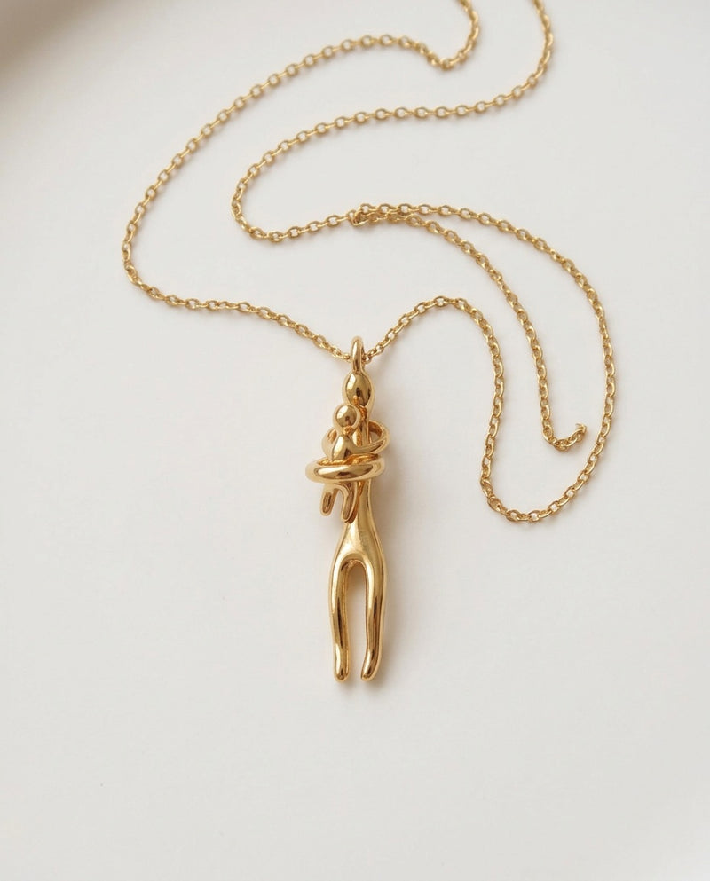 Mom necklace with gold mother and child hug pendant on a fine chain