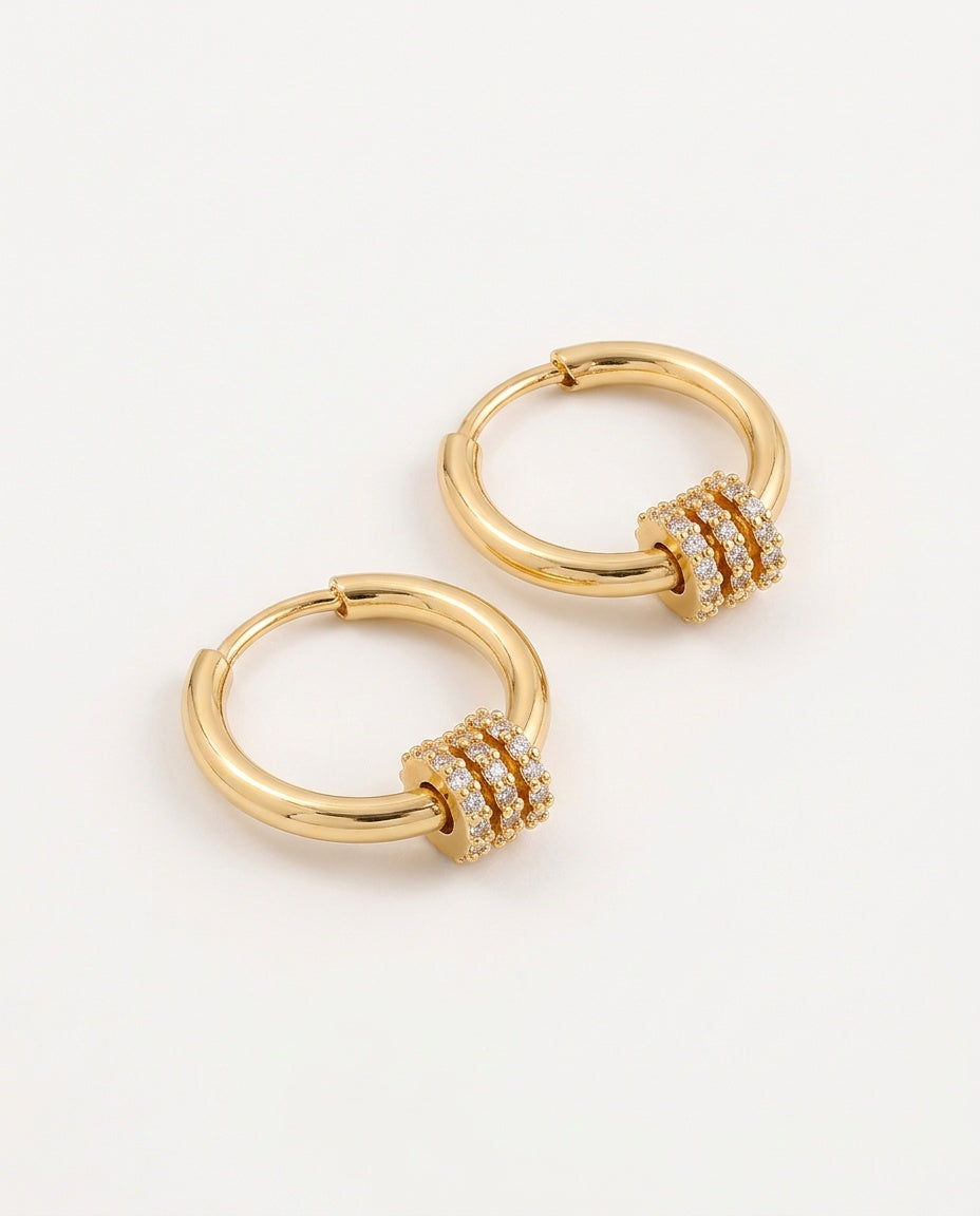 Charm hoop earrings in gold tone with a zirconia charm