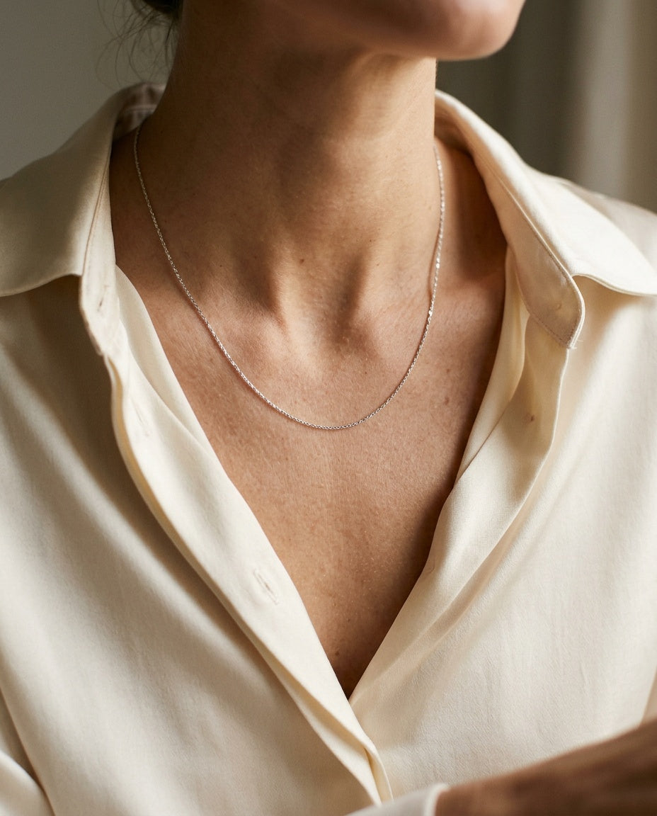 Chain necklace worn at collarbone length
